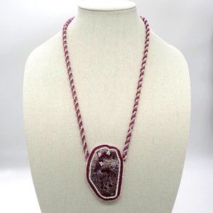 Necklace with seed beads and large stone.